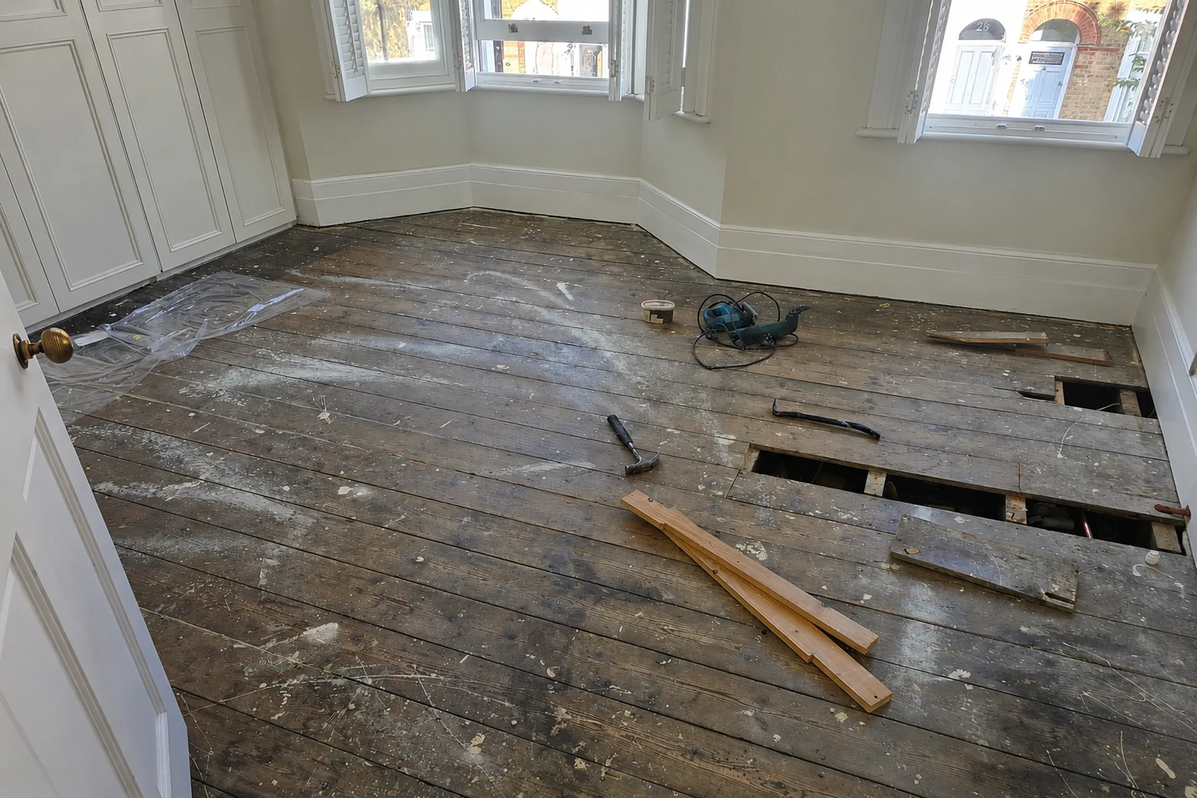 Worn and scratched wooden floor before restoration