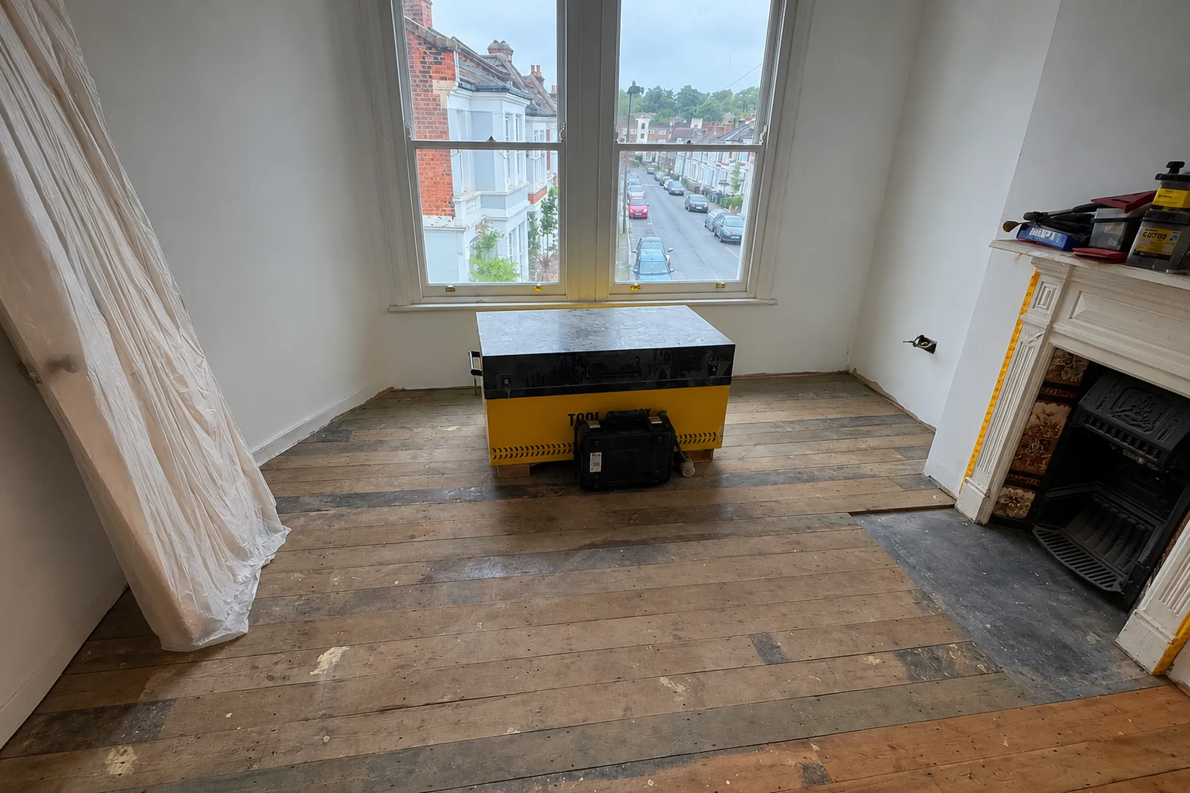 Dark worn wooden floor before professional sanding